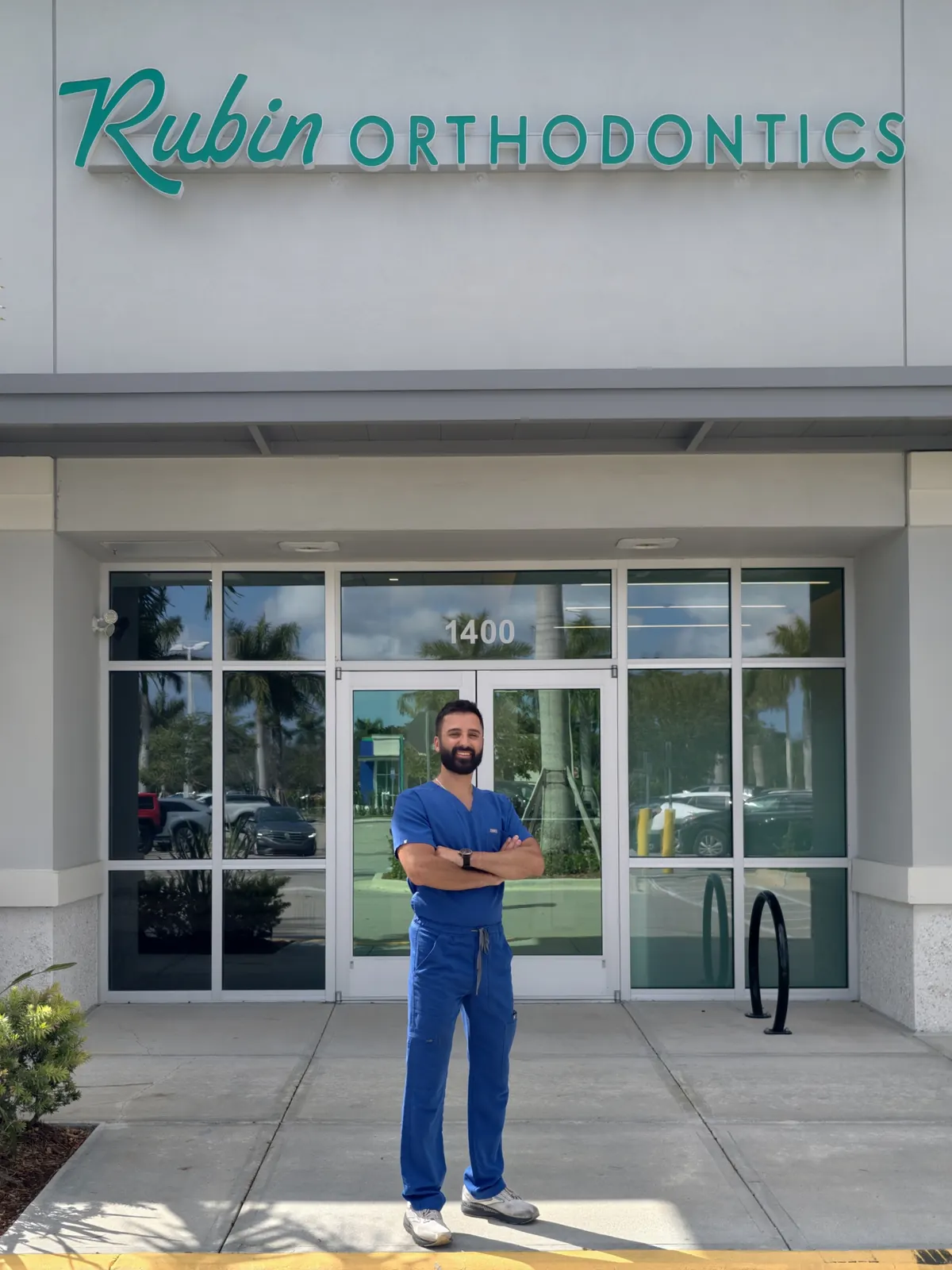 The entrance to Rubin Orthodontics at 16841 Persimmon Blvd Suite 1400, with the green Rubin Orthodontics sign above the glass doors
